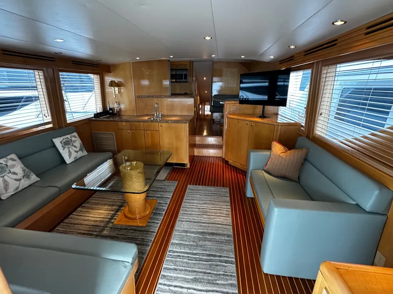Slide: The Image of Interior of a 2000 Hatteras 70 Convertible with elegant wood furnishings and modern amenities. - 5