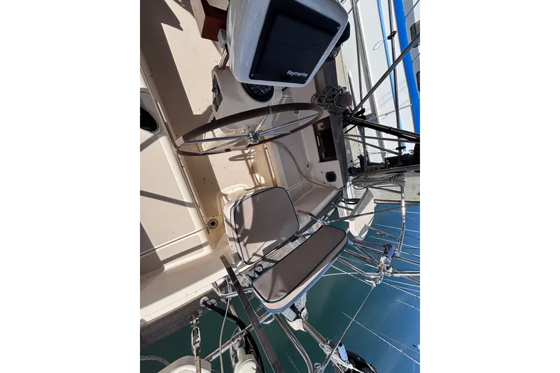 Slide: The Image of Cockpit of 2000 Island Packet 380 sailboat with steering wheel and navigation equipment. - 44