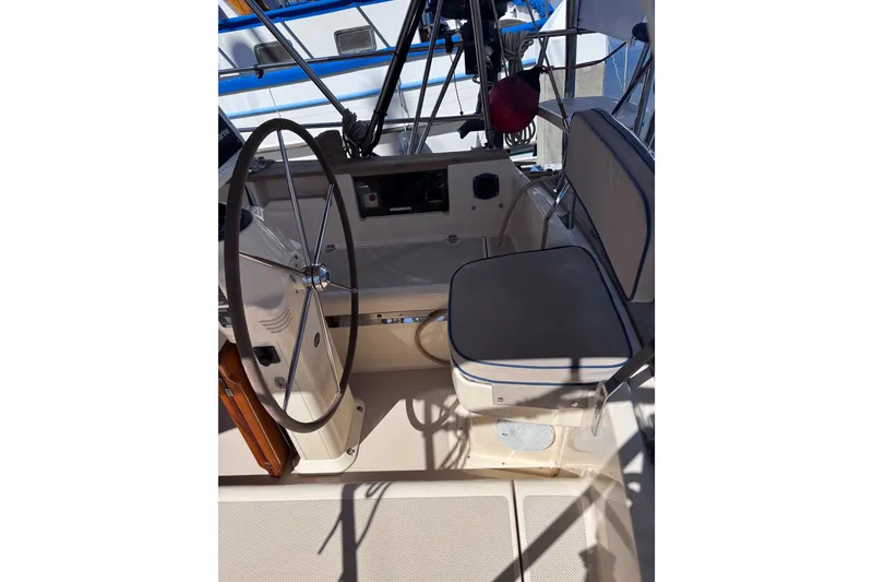 Slide: The Image of Cockpit of 2000 Island Packet 380 sailboat with steering wheel and seating. - 56