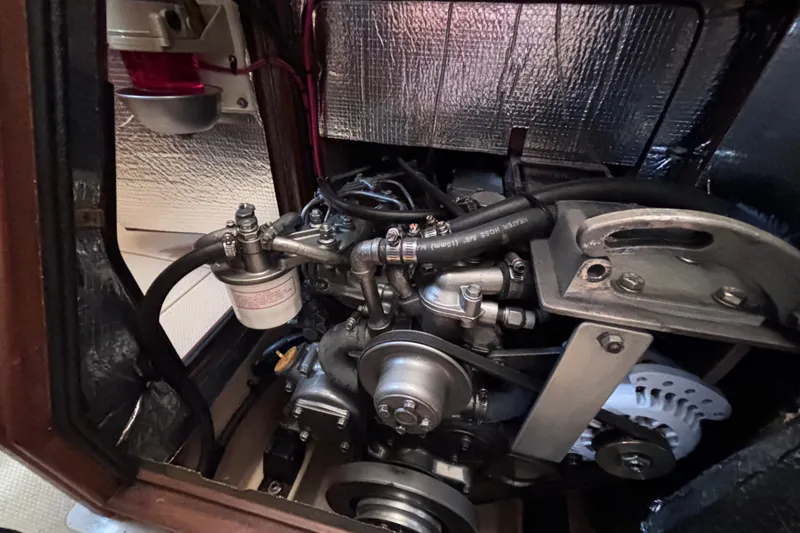 Slide: The Image of Engine compartment of a 2000 Island Packet 380 sailboat, showcasing mechanical components. - 30
