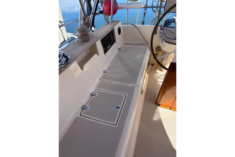 Slide: The Image of Cockpit of 2000 Island Packet 380 sailboat with seating and steering wheel. - 61