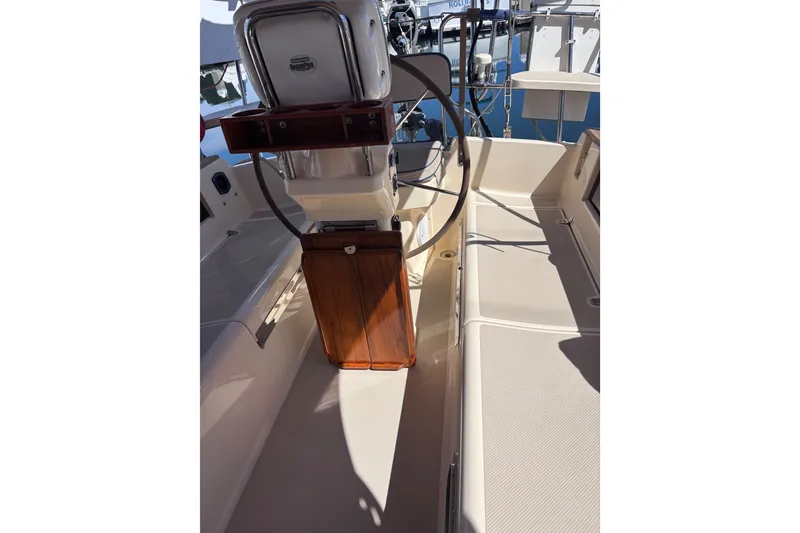 Slide: The Image of Cockpit of 2000 Island Packet 380 sailboat with steering wheel and wooden accents. - 62
