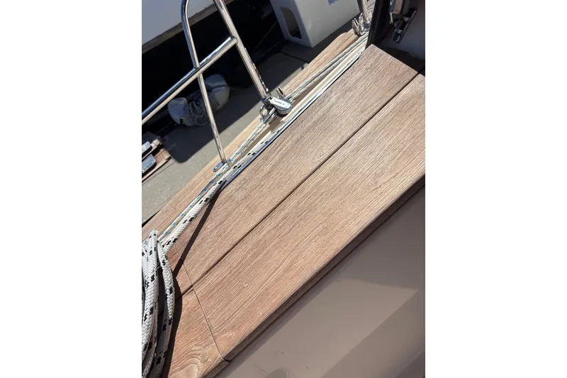 Slide: The Image of Wooden deck of 2000 Island Packet 380 sailboat with ropes and railing. - 58