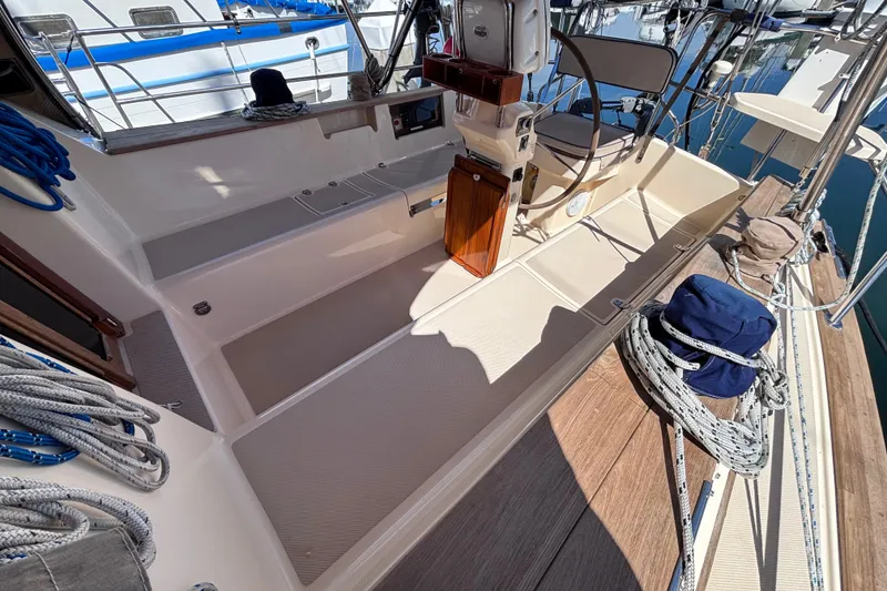 Slide: The Image of Cockpit of 2000 Island Packet 380 sailboat with steering wheel and ropes. - 54