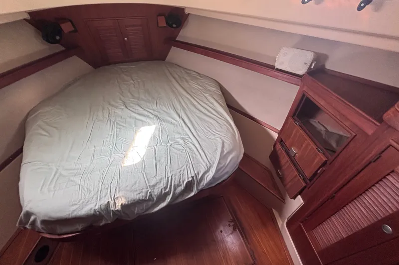 Slide: The Image of Cozy cabin interior of 2000 Island Packet 380 sailboat with wooden furnishings. - 16