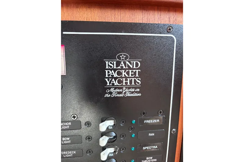 Slide: The Image of Control panel of a 2000 Island Packet 380 yacht with labeled switches. - 13