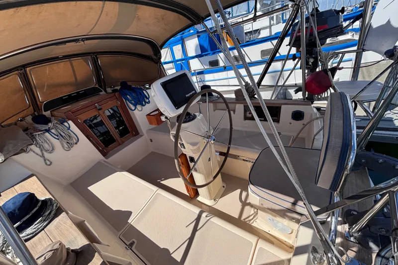 Slide: The Image of Cockpit of 2000 Island Packet 380 sailboat with steering wheel and navigation equipment. - 55