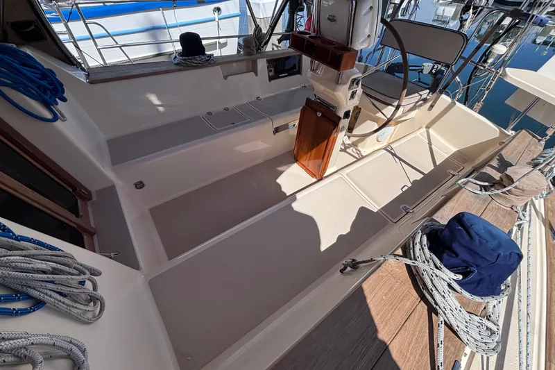 Slide: The Image of Cockpit of 2000 Island Packet 380 sailboat with steering wheel and ropes. - 53