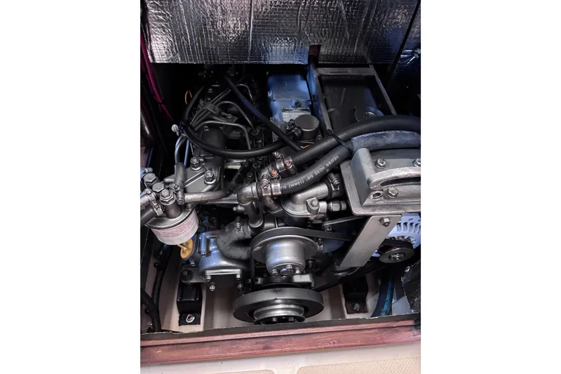 Slide: The Image of Engine compartment of a 2000 Island Packet 380 sailboat, showcasing mechanical components. - 31