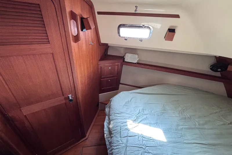 Slide: The Image of Cozy cabin interior of 2000 Island Packet 380 sailboat with wooden furnishings. - 24