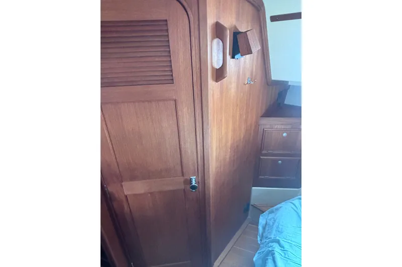 Slide: The Image of Interior of 2000 Island Packet 380 sailboat with wooden cabinetry and storage. - 19