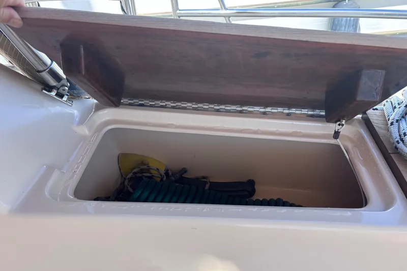 Slide: The Image of Open storage compartment on 2000 Island Packet 380 sailboat, containing coiled ropes and gear. - 60