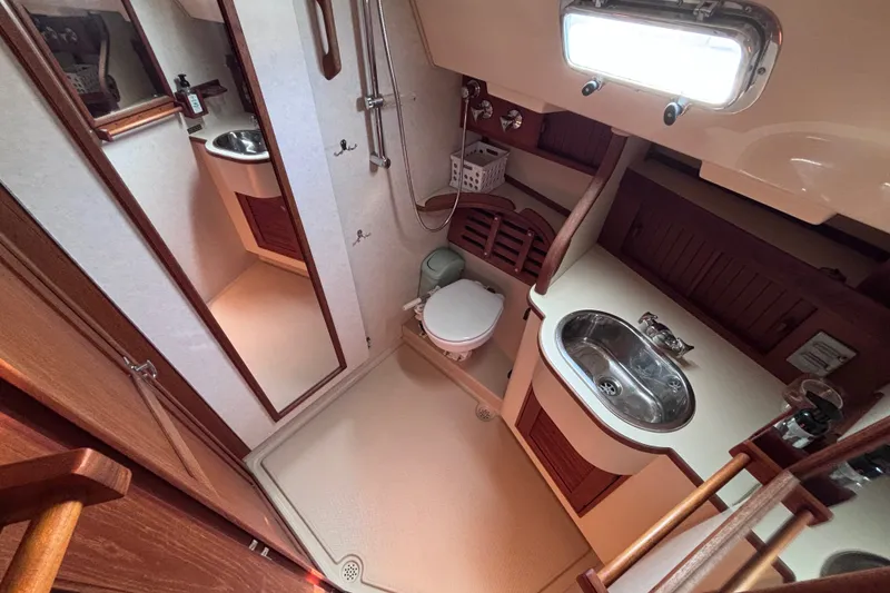 Slide: The Image of Bathroom interior of 2000 Island Packet 380 yacht, featuring sink, toilet, and shower. - 22