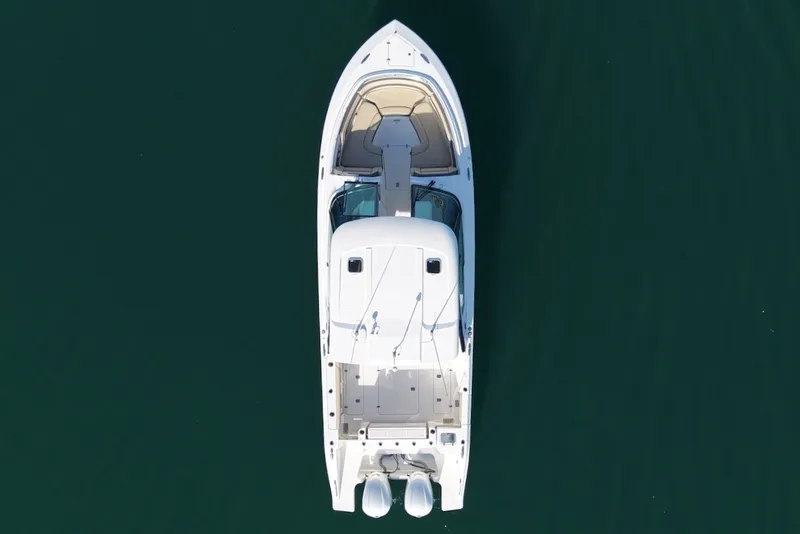 Slide: The Image of Aerial view of a 2021 Pursuit DC 326 Dual Console boat on calm water. - 2