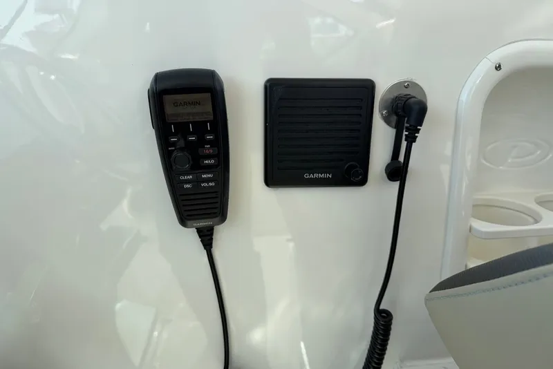 Slide: The Image of Radio and speaker mounted on the wall of a Pursuit DC 326 Dual Console boat. - 34