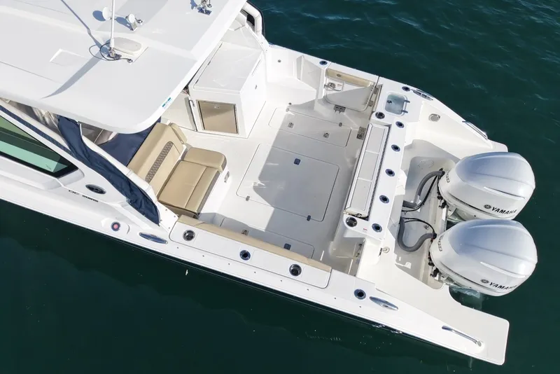 Slide: The Image of Aerial view of a Pursuit DC 326 Dual Console boat with twin Yamaha engines and spacious deck. - 3
