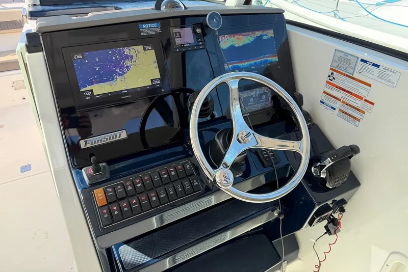 Slide: The Image of Helm of the Pursuit DC 326 Dual Console with modern navigation systems and controls. - 29