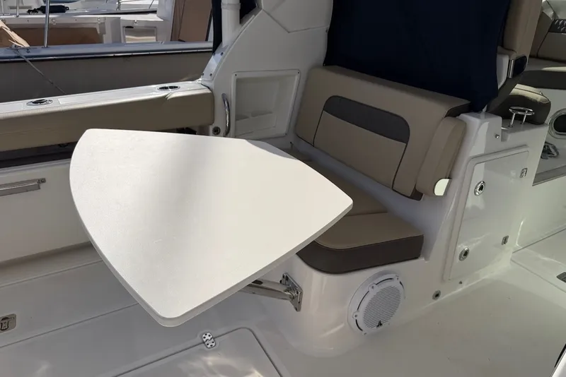 Slide: The Image of Interior of a Pursuit DC 326 Dual Console with a foldable table and cushioned seating. - 17