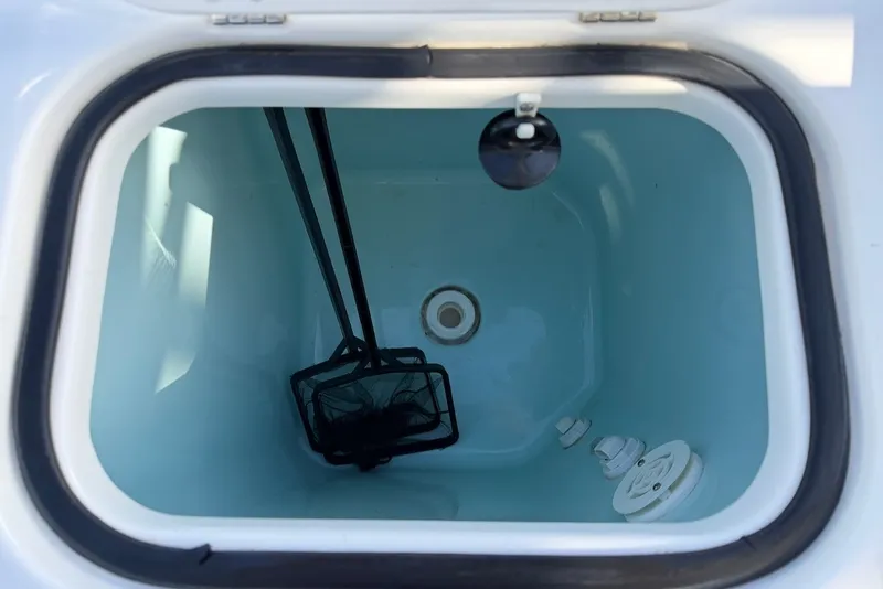 Slide: The Image of An open storage compartment with a net and a drain inside. - 10