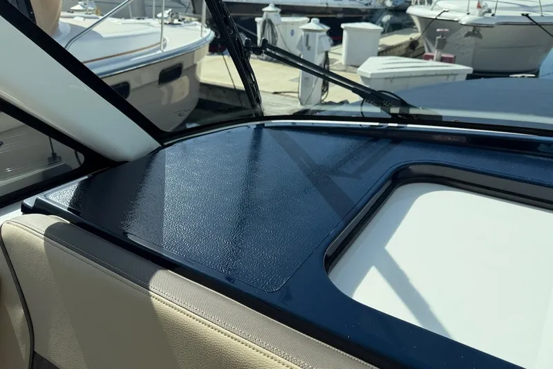 Slide: The Image of The image shows the dashboard of a 2021 Pursuit DC 326 Dual Console boat. - 39