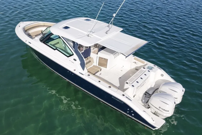 Slide: The Image of 2021 Pursuit DC 326 Dual Console on calm water with twin Yamaha engines. - 6