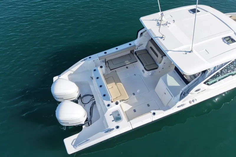 Slide: The Image of Aerial view of a 2021 Pursuit DC 326 Dual Console boat on calm water. - 8