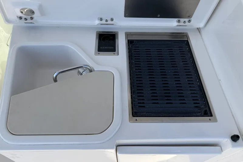 Slide: The Image of The 2021 Pursuit DC 326 Dual Console features a sink and built-in grill. - 19