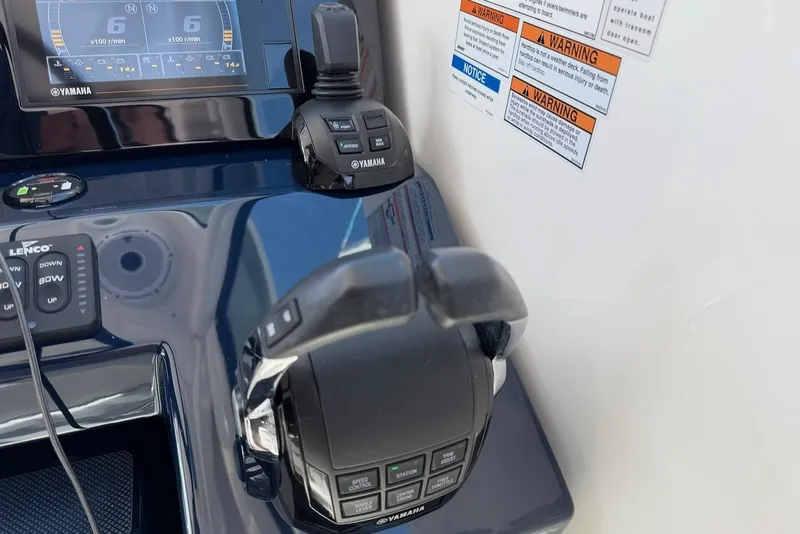 Slide: The Image of Close-up of the helm console with Yamaha controls and warning labels. - 33