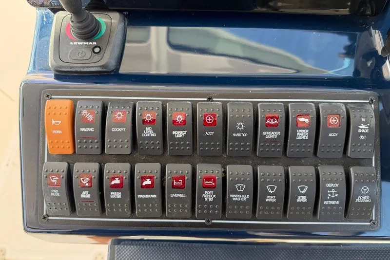 Slide: The Image of Control panel of a Pursuit DC 326 Dual Console boat with various switches and indicators. - 35