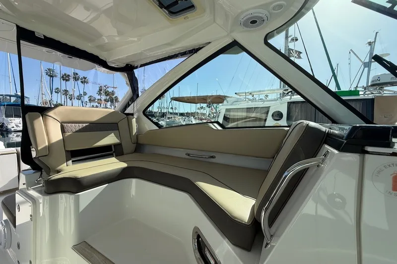 Slide: The Image of Interior of a 2021 Pursuit DC 326 Dual Console with sleek seating and large windows. - 26