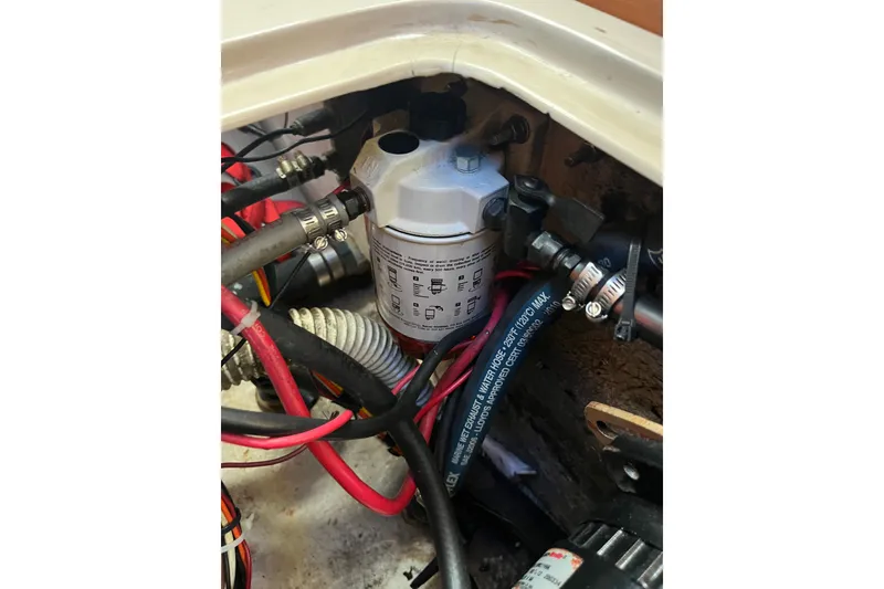 Slide: The Image of Engine compartment of a 1985 Catalina 30 sailboat with visible fuel filter and hoses. - 37
