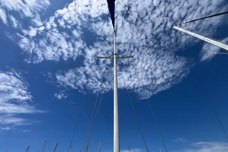 Slide: The Image of Mast of 1985 Catalina 30 sailboat against a blue sky with clouds. - 5