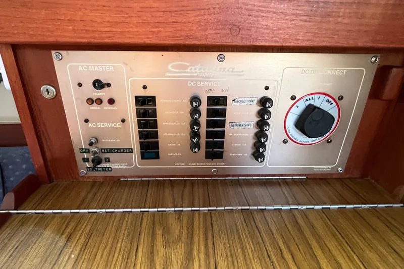Slide: The Image of Electrical panel of a 1985 Catalina 30 sailboat with AC and DC service controls. - 33