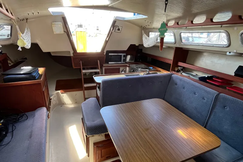 Slide: The Image of Interior of a 1985 Catalina 30 sailboat with dining area and kitchenette. - 15