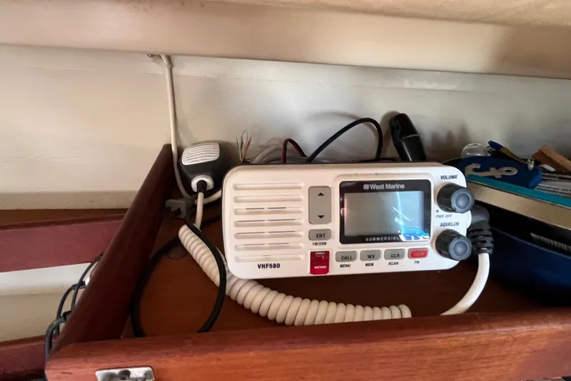 Slide: The Image of VHF radio on 1985 Catalina 30 sailboat shelf, featuring West Marine model. - 34