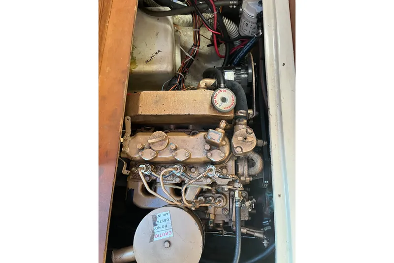 Slide: The Image of Engine compartment of a 1985 Catalina 30 sailboat, showing detailed mechanical components. - 35