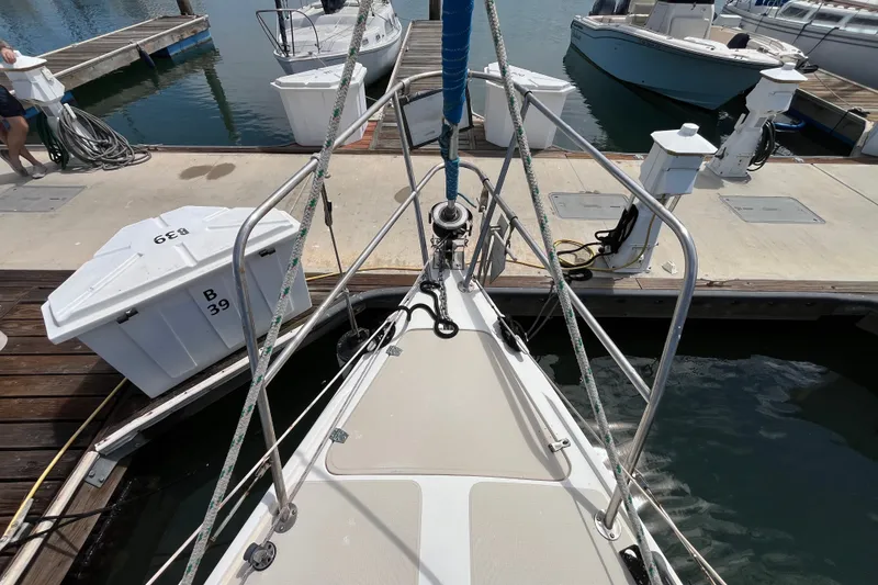 Slide: The Image of Bow view of a 1985 Catalina 30 sailboat docked at a marina. - 3