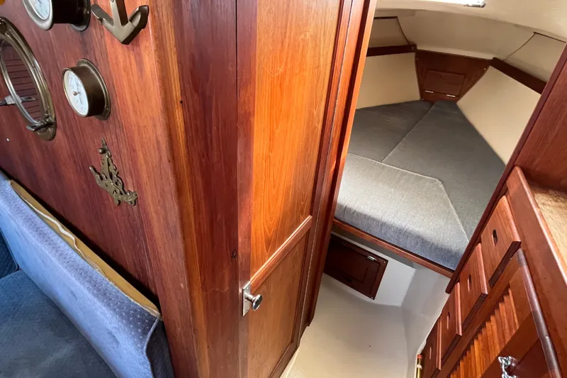 Slide: The Image of Interior of a 1985 Catalina 30 sailboat with cozy wooden cabin and sleeping berth. - 29
