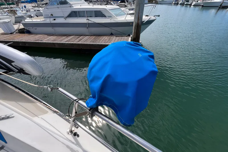 Slide: The Image of Catalina 30 sailboat, 1985 model, with blue cover at marina dock. - 9