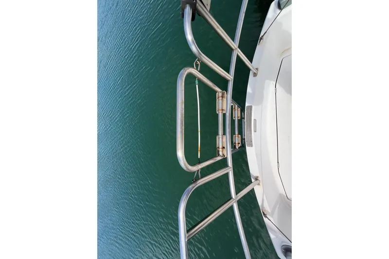 Slide: The Image of Bow view of 1985 Catalina 30 sailboat with stainless steel railing over water. - 7