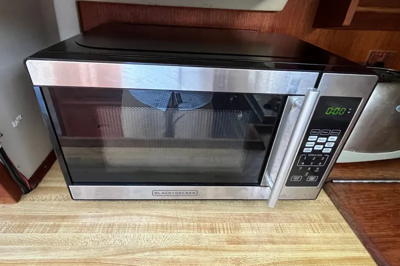 Slide: The Image of Black+Decker microwave on wooden countertop in Catalina 30, 1985 model boat kitchen. - 25