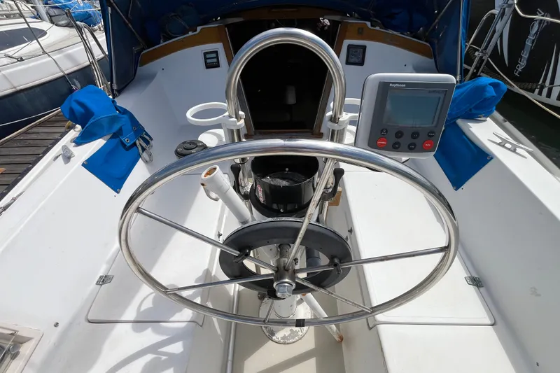Slide: The Image of Cockpit of a 1985 Catalina 30 sailboat with steering wheel and navigation equipment. - 8