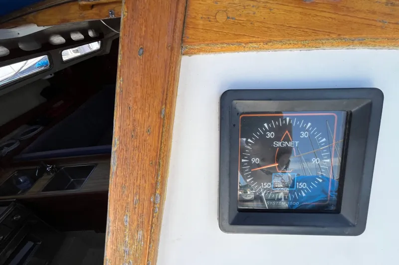 Slide: The Image of Signet gauge on 1985 Catalina 30 sailboat, wooden interior visible. - 13