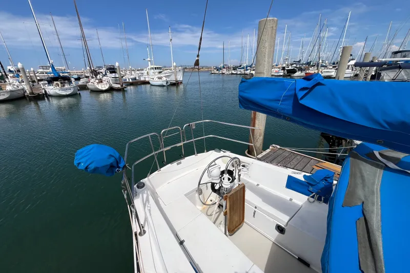 Slide: The Image of Sailboat docked in marina, Catalina 30 model, 1985, with blue covers and clear sky. - 6