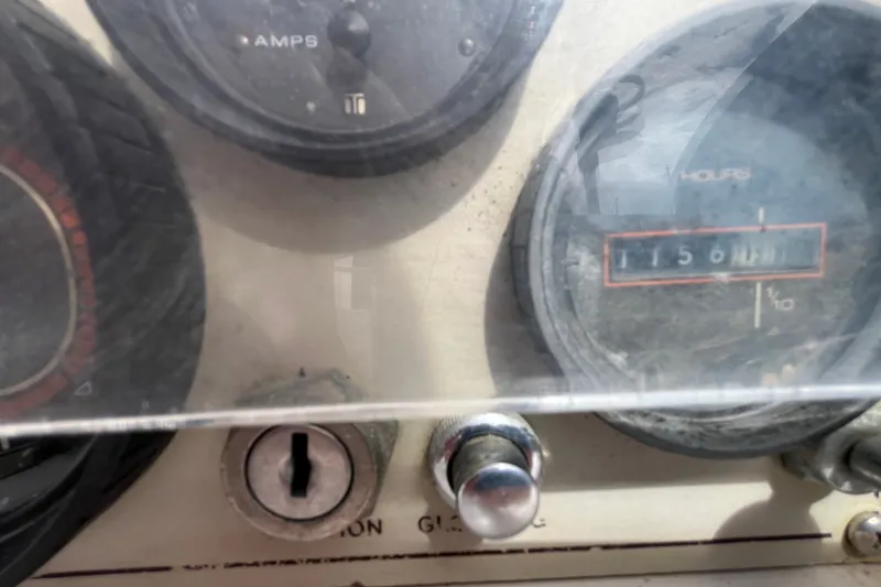 Slide: The Image of Close-up of a 1985 Catalina 30 boat dashboard with gauges and ignition key. - 11