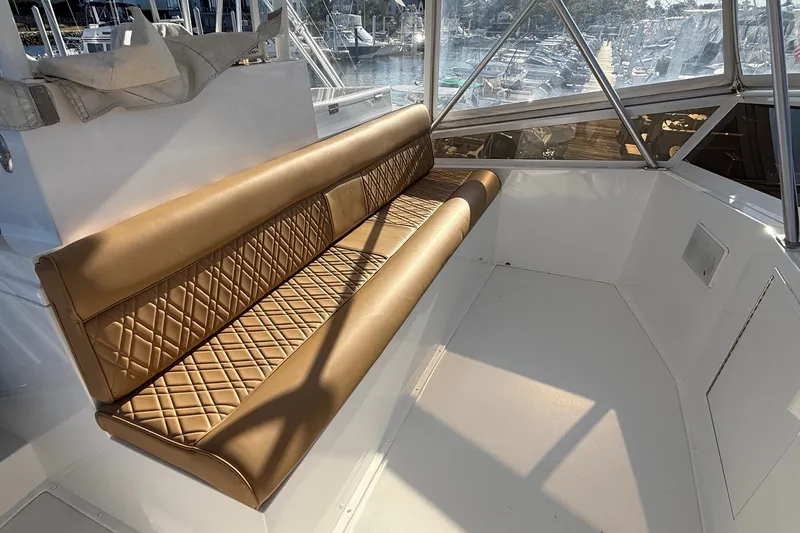 Slide: The Image of Luxurious seating on 1989 Viking 48 Convertible yacht, featuring diamond-stitched leather upholstery. - 13