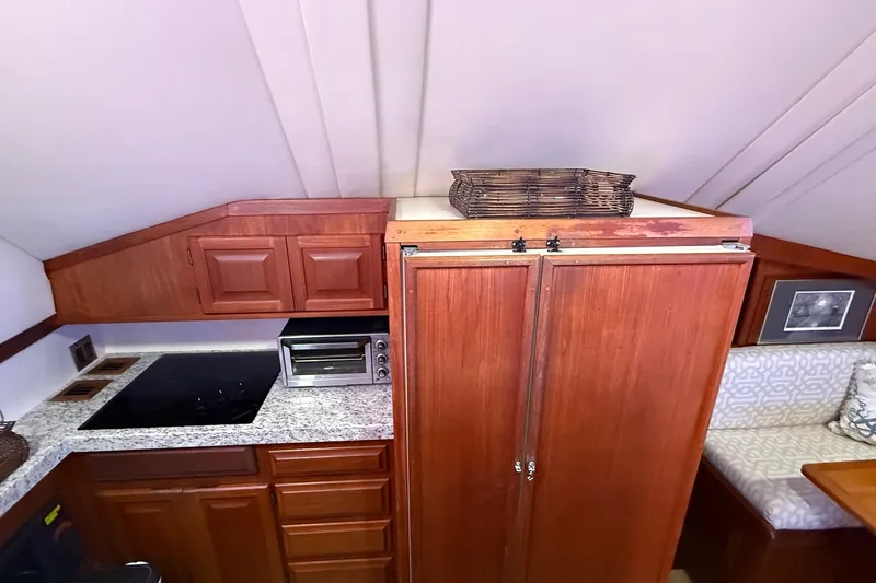 Slide: The Image of Interior of 1989 Viking 48 Convertible yacht with wooden cabinets and modern appliances. - 19