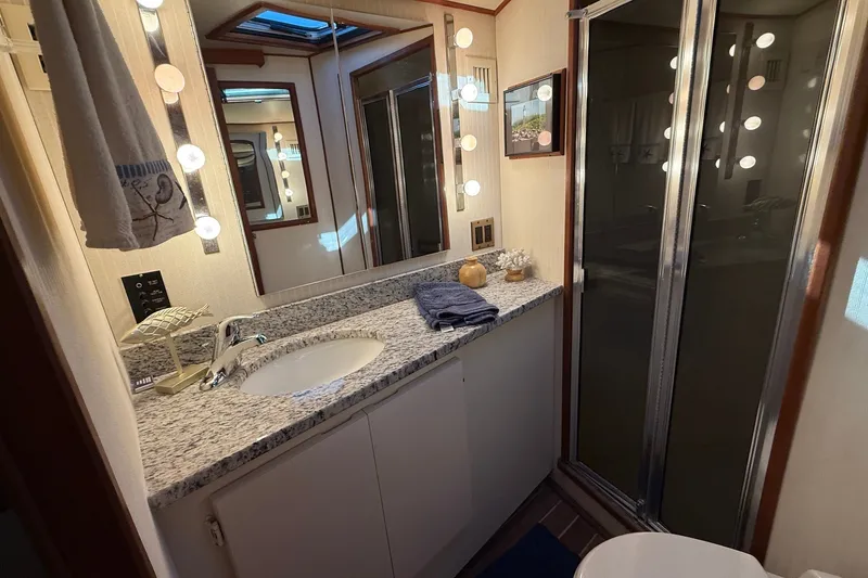 Slide: The Image of Luxurious bathroom in 1989 Viking 48 Convertible yacht with granite countertop and shower. - 32