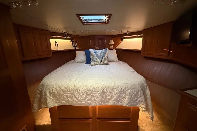 Slide: The Image of Luxurious cabin interior of 1989 Viking 48 Convertible yacht with cozy bed and wooden cabinetry. - 25
