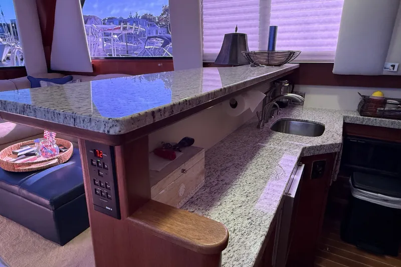 Slide: The Image of Luxurious kitchen interior of 1989 Viking 48 Convertible yacht with granite countertops. - 23